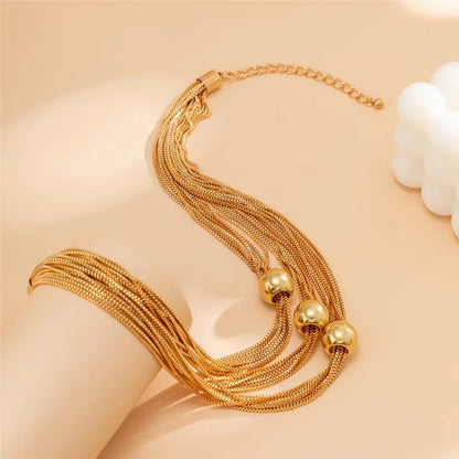 Nocturne draperat halsband med bollar